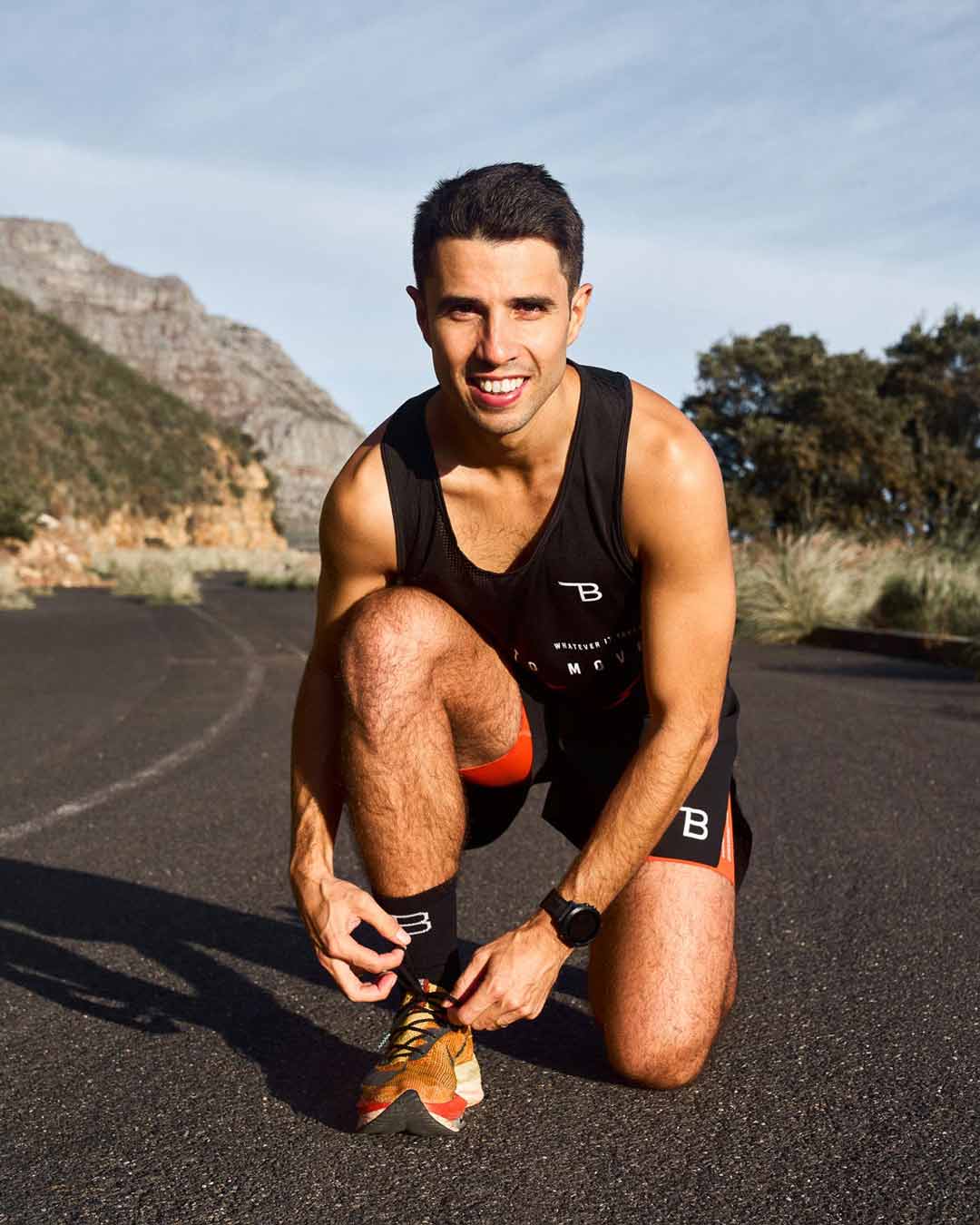 Nic Acampora, the Full Marathon Kickstart running coach, tying his shoelace and getting ready for a run, inspiring runners to prepare for their training.